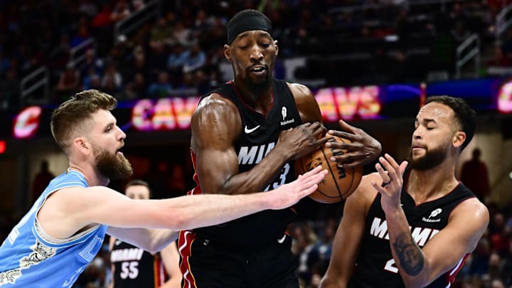 Mar 5, 2025; Cleveland, Ohio, USA; Miami Heat center Bam Adebayo (13) goes for a rebound against Cleveland Cavaliers forward Dean Wade (32) during the second half at Rocket Arena. Mandatory Credit: Ken Blaze-Imagn Images