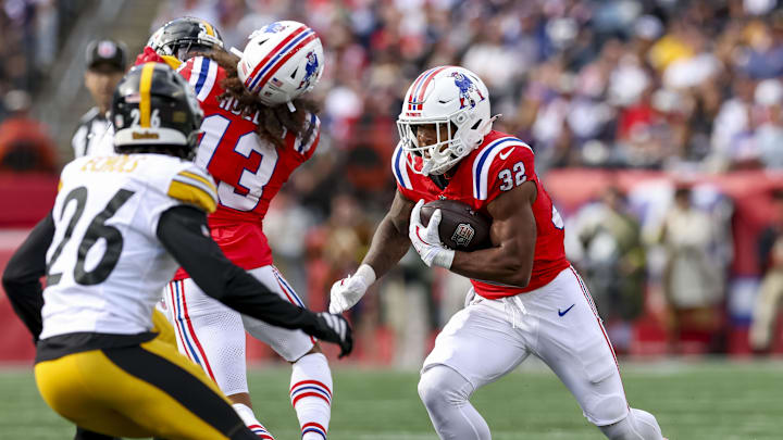 Sep 21, 2025; Foxborough, Massachusetts, USA; New England Patriots running back Treveyon Henderson (32) runs the ball during the third quarter at Gillette Stadium. Mandatory Credit: Paul Rutherford-Imagn Images