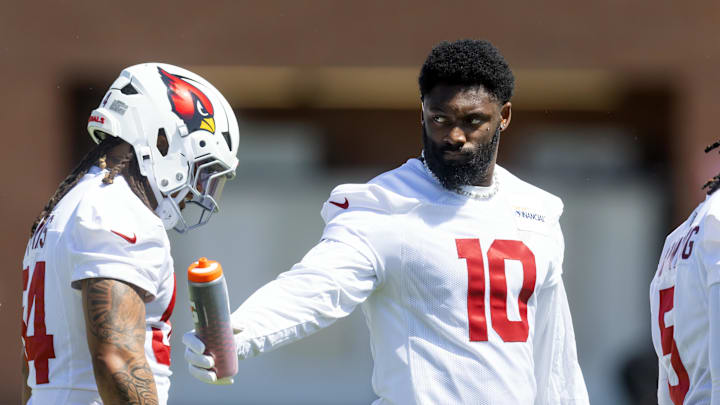 Jun 10, 2025; Tempe, AZ, USA; Arizona Cardinals linebacker Josh Sweat (10) shares water with a teammate during minicamp at the teams Arizona Cardinals Training Facility. Mandatory Credit: Mark J. Rebilas-Imagn Images