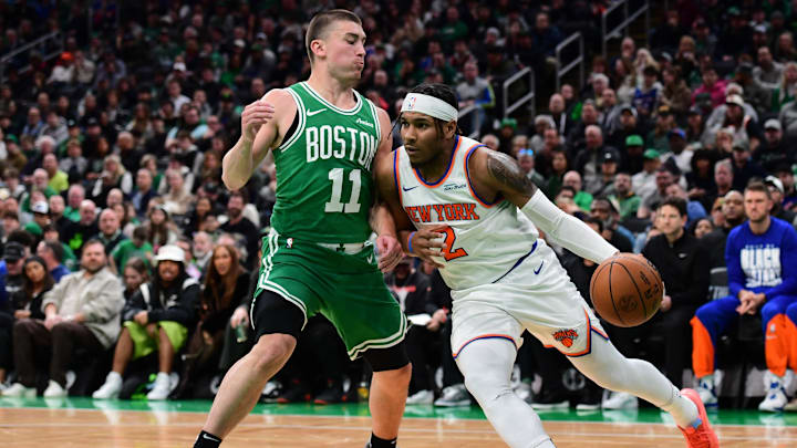 New York Knicks guard Miles McBride controls the ball while Boston Celtics guard Payton Pritchard defends. New York Knicks guard Miles McBride controls the ball while Boston Celtics guard Payton Pritchard defends.