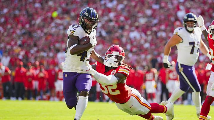 Sep 28, 2025; Kansas City, Missouri, USA; Baltimore Ravens running back Justice Hill (43) runs for a touchdown against Kansas City Chiefs linebacker Nick Bolton (32) during the first half at GEHA Field at Arrowhead Stadium. Mandatory Credit: Jay Biggerstaff-Imagn Images