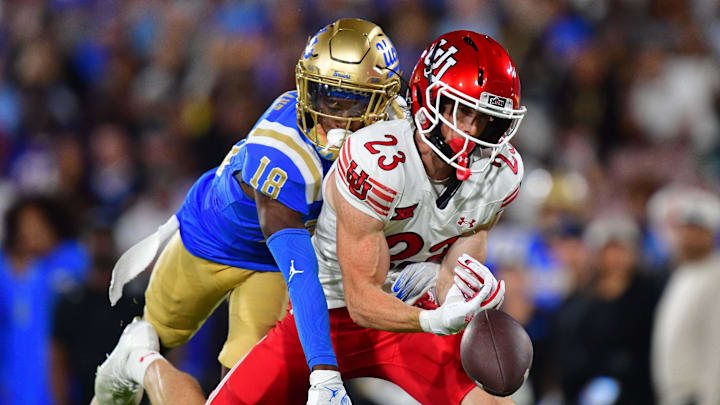Aug 30, 2025; Pasadena, California, USA; Utah Utes safety Jackson Bennee (23) on offense misses catching a pass against the defense of UCLA Bruins defensive back Jadyn Marshall (18) during the first half at Rose Bowl. Mandatory Credit: Gary A. Vasquez-Imagn Images