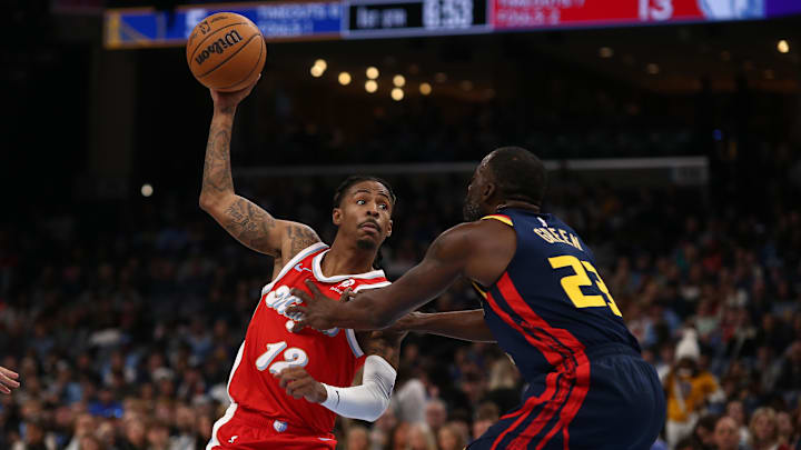 Dec 19, 2024; Memphis, Tennessee, USA; Memphis Grizzlies guard Ja Morant (12) drives to the basket as Golden State Warriors forward Draymond Green (23) defends during the first quarter at FedExForum. 