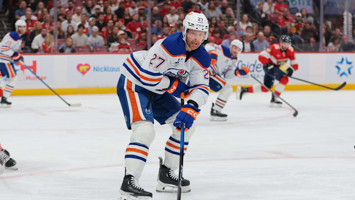Nov 22, 2025; Sunrise, Florida, USA; Edmonton Oilers defenseman Brett Kulak (27) moves the puck against the Florida Panthers during the first period at Amerant Bank Arena. Mandatory Credit: Sam Navarro-Imagn Images