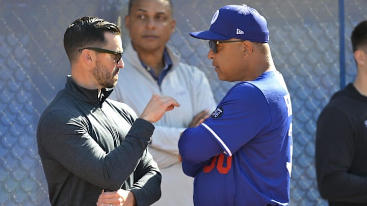 Feb 18, 2025; Glendale, AZ, USA;  Los Angeles Dodgers Executive Vice President and General Manager Brandon Gomes talks with manager Dave Roberts (30) during spring training at Camelback Ranch. Mandatory Credit: Jayne Kamin-Oncea-Imagn Images