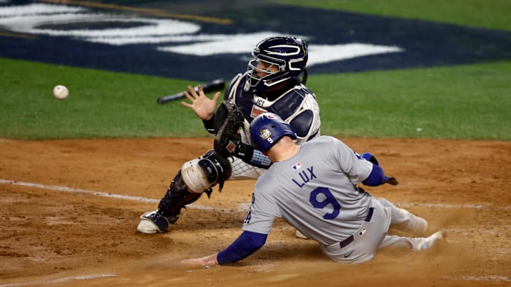 Los Angeles Dodgers second baseman Gavin Lux (9) scores against New York Yankees catcher Jose Trevino (39) during the sixth inning in game three of the 2024 MLB World Series at Yankee Stadium.