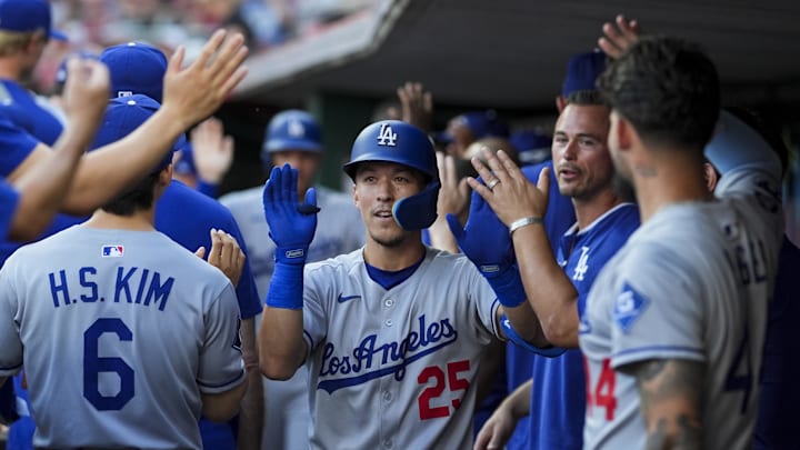 Jul 29, 2025; Cincinnati, Ohio, USA;  Los Angeles Dodgers second baseman Tommy Edman (25) celebrates with teammates after hitting a two-run home run against the Cincinnati Reds in the second inning at Great American Ball Park. Mandatory Credit: Aaron Doster-Imagn Images