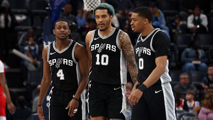 Mar 1, 2025; Memphis, Tennessee, USA; San Antonio Spurs forward Jeremy Sochan (10) reacts with guard De'Aaron Fox (4) and forward Keldon Johnson (0) during a time out during the second quarter against the Memphis Grizzlies at FedExForum. Mandatory Credit: Petre Thomas-Imagn Images