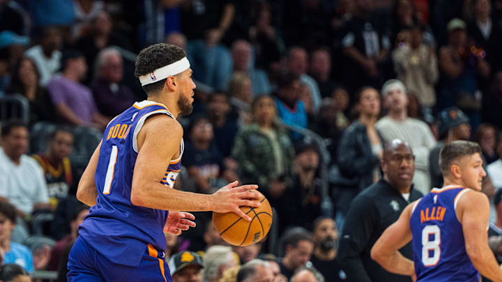 Nov 10, 2024; Phoenix, Arizona, USA; Phoenix Suns guard Devin Booker (1) moves the ball down the court in overtime during a game against the Sacramento Kings at Footprint Center. Mandatory Credit: Allan Henry-Imagn Images