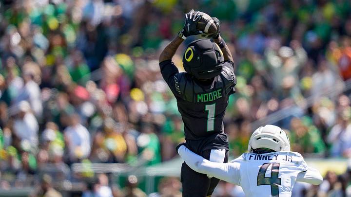Combat Ducks wide receiver Dakorien Moore brings down a reception under cover from Fighting Ducks defensive back Brandon Finney Jr. during the Oregon Ducks annual spring game on April 25, 2026 at Autzen Stadium in Eugene, Oregon.