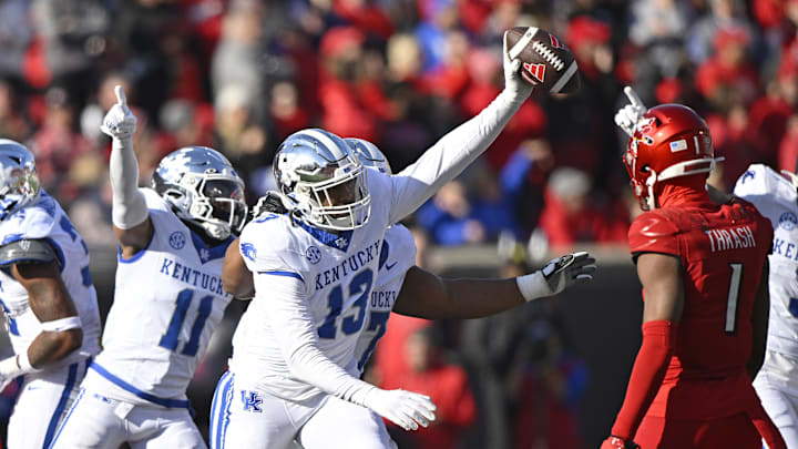 Nov 25, 2023; Louisville, Kentucky, USA;  Kentucky Wildcats linebacker J.J. Weaver (13) celebrates a fumble recovery during the second half against the Louisville Cardinals at L&N Federal Credit Union Stadium. Kentucky defeated Louisville 38-31. Mandatory Credit: Jamie Rhodes-Imagn Images