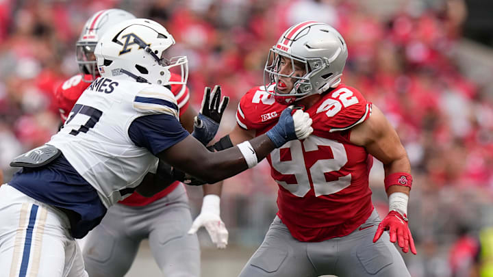 Aug 31, 2024; Columbus, OH, USA; Ohio State Buckeyes defensive end Caden Curry (92) fights through the block of Akron Zips offensive lineman Jayvin James (77) during the NCAA football game at Ohio Stadium. Ohio State won 52-6.