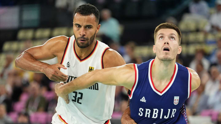Aug 10, 2024; Paris, France; Germany power forward Johannes Thiemann (32) battles for position against Serbia centre Filip Petrusev (3) in the men's basketball bronze medal game during the Paris 2024 Olympic Summer Games at Accor Arena. Mandatory Credit: Rob Schumacher-USA TODAY Sports