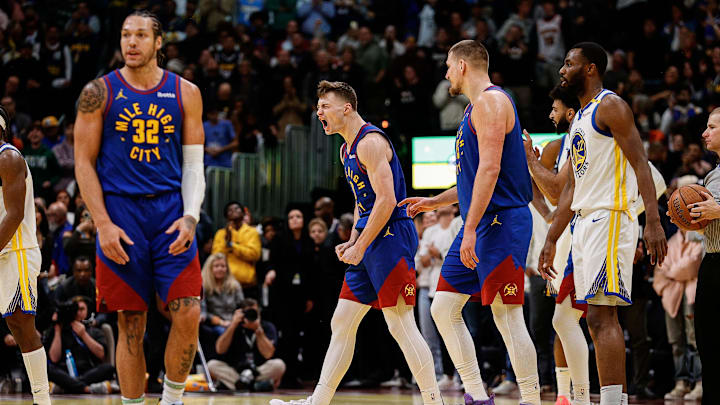 Dec 3, 2024; Denver, Colorado, USA; Denver Nuggets guard Christian Braun (0) reacts after a play as center Nikola Jokic (15) and forward Aaron Gordon (32) and Golden State Warriors forward Andrew Wiggins (22) look on in the fourth quarter at Ball Arena. Mandatory Credit: Isaiah J. Downing-Imagn Images Dec 3, 2024; Denver, Colorado, USA; Denver Nuggets guard Christian Braun (0) reacts after a play as center Nikola Jokic (15) and forward Aaron Gordon (32) and Golden State Warriors forward Andrew Wiggins (22) look on in the fourth quarter at Ball Arena. Mandatory Credit: Isaiah J. Downing-Imagn Images