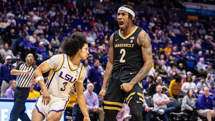 Jan 4, 2025; Baton Rouge, Louisiana, USA;  Vanderbilt Commodores guard MJ Collins Jr. (2) reacts after dunking against LSU Tigers guard Curtis Givens III (3) during the second half at Pete Maravich Assembly Center.