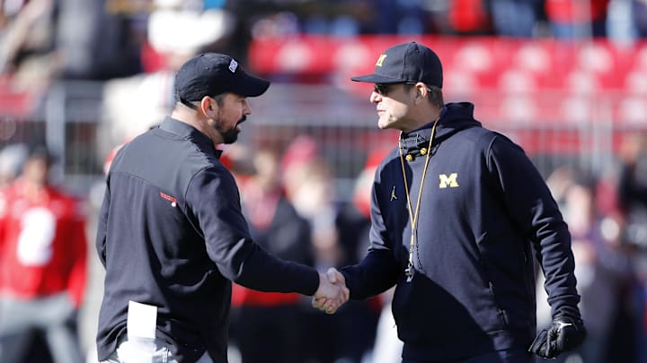 Nov 26, 2022; Columbus, Ohio, USA; Michigan Wolverines head coach Jim Harbaugh (right) and Ohio State Buckeyes head coach Ryan Day (left) shake hands before the game at Ohio Stadium. Mandatory Credit: Joseph Maiorana-Imagn Images