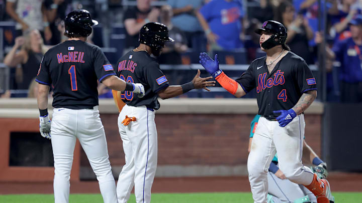 Aug 15, 2025; New York City, New York, USA; New York Mets catcher Francisco Alvarez (4) celebrates his three run home run against the Seattle Mariners with center fielder Cedric Mullins (28) and second baseman Jeff McNeil (1) during the eighth inning at Citi Field. Mandatory Credit: Brad Penner-Imagn Images