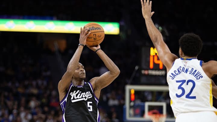Oct 11, 2024; San Francisco, California, USA; Sacramento Kings guard De'Aaron Fox (5) shoots over Golden State Warriors forward Trayce Jackson-Davis (32) during the second quarter at Chase Center. Mandatory Credit: D. Ross Cameron-Imagn Images