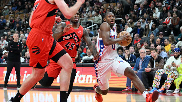 Oct 25, 2024; Toronto, Ontario, CAN;  Philadelphia 76ers guard Tyrese Maxey (0) drives to the basket past Toronto Raptors guard Davion Mitchell (45) in the first half at Scotiabank Arena. Mandatory Credit: Dan Hamilton-Imagn Images