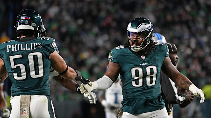 Nov 16, 2025; Philadelphia, Pennsylvania, USA;  Philadelphia Eagles defensive tackle Jalen Carter (98) celebrates a stop with linebacker Jaelan Phillips (50) against the Detroit Lions at Lincoln Financial Field. Mandatory Credit: Eric Hartline-Imagn Images