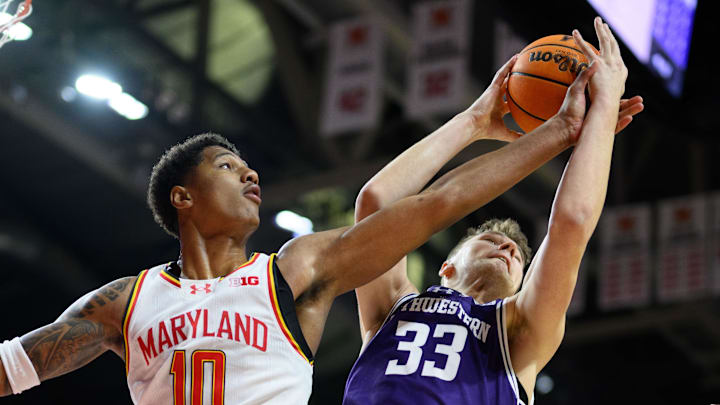 Mar 8, 2025; College Park, Maryland, USA; Maryland Terrapins forward Julian Reese (10) and Northwestern Wildcats forward Luke Hunger (33) battle for a rebound during the first half at Xfinity Center. Mandatory Credit: Reggie Hildred-Imagn Images