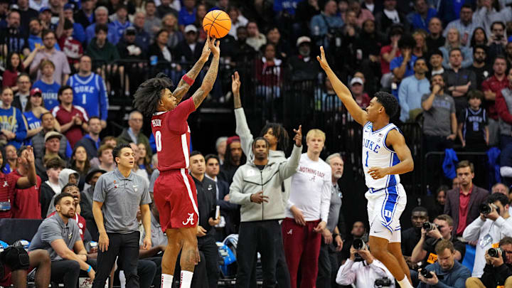 Mar 29, 2025; Newark, NJ, USA; Alabama Crimson Tide guard Labaron Philon (0) shoots the ball against Duke Blue Devils guard Caleb Foster (1) during the second half in the East Regional final of the 2025 NCAA tournament at Prudential Center. Mandatory Credit: Robert Deutsch-Imagn Images