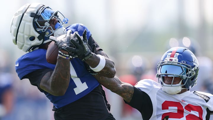 Aug 4, 2025; East Rutherford, NJ, USA; New York Giants wide receiver Malik Nabers (1) catches the ball as cornerback Dru Phillips (22) defends during training camp at Quest Diagnostics Training Center. Mandatory Credit: Vincent Carchietta-Imagn Images Aug 4, 2025; East Rutherford, NJ, USA; New York Giants wide receiver Malik Nabers (1) catches the ball as cornerback Dru Phillips (22) defends during training camp at Quest Diagnostics Training Center. Mandatory Credit: Vincent Carchietta-Imagn Images