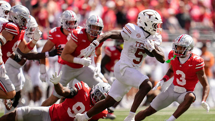 Texas Longhorns running back Quintrevion Wisner (5) runs past Ohio State Buckeyes defensive end Eddrick Houston (96) during the second half of the NCAA football game at Ohio Stadium on Aug. 30, 2025. Ohio State won 14-7. Texas Longhorns running back Quintrevion Wisner (5) runs past Ohio State Buckeyes defensive end Eddrick Houston (96) during the second half of the NCAA football game at Ohio Stadium on Aug. 30, 2025. Ohio State won 14-7.