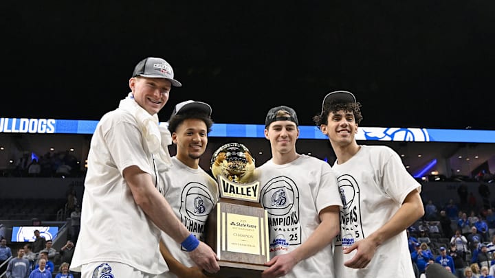 Mar 9, 2025; St. Louis, Missouri, USA; Drake Bulldogs forward Nate Ferguson (24) guard Isaiah Jackson (4) guard Mitch Mascari (22) and forward Daniel Abreu (54) hold the trophy after defeating the Bradley Braves to win the Missouri Valley Conference Tournament Championship at Enterprise Center. Mandatory Credit: Jeff Curry-Imagn Images Mar 9, 2025; St. Louis, Missouri, USA; Drake Bulldogs forward Nate Ferguson (24) guard Isaiah Jackson (4) guard Mitch Mascari (22) and forward Daniel Abreu (54) hold the trophy after defeating the Bradley Braves to win the Missouri Valley Conference Tournament Championship at Enterprise Center. Mandatory Credit: Jeff Curry-Imagn Images