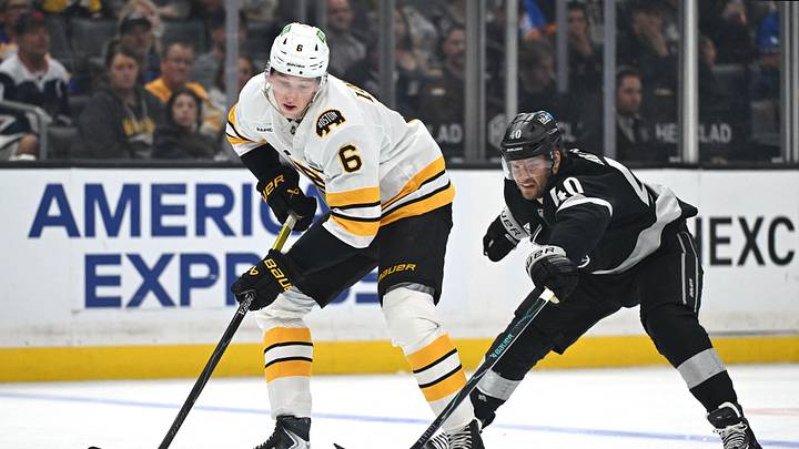 Oct 17, 2026; Los Angeles, California, USA;  Boston Bruins defenseman Mason Lohrei (6) skates with the puck against Los Angeles Kings right wing Joel Armia (40) during the second period at Crypto.com Arena.  Mandatory Credit: Griffin Hooper-Imagn Images