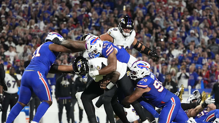 Sep 7, 2025; Orchard Park, New York, USA;  Buffalo Bills defensive end Greg Rousseau (50) tackles Baltimore Ravens quarterback Lamar Jackson (8) during the first quarter at Highmark Stadium. Mandatory Credit: Gregory Fisher-Imagn Images