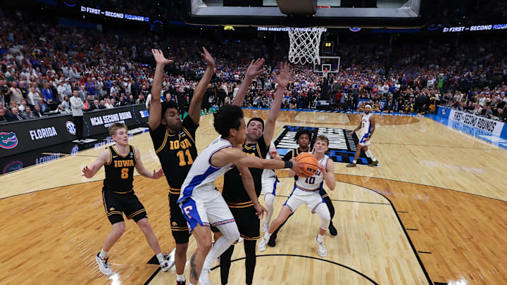 Mar 22, 2026; Tampa, FL, USA; Florida Gators guard Xaivian Lee (1) passes the ball around Iowa Hawkeyes forward Alvaro Folgueiras (7) in the final seconds as Florida Gators was unable to get a shot off in the second half during a second round game of the men's 2026 NCAA Tournament at Benchmark International Arena. Mandatory Credit: Nathan Ray Seebeck-Imagn Images Mar 22, 2026; Tampa, FL, USA; Florida Gators guard Xaivian Lee (1) passes the ball around Iowa Hawkeyes forward Alvaro Folgueiras (7) in the final seconds as Florida Gators was unable to get a shot off in the second half during a second round game of the men's 2026 NCAA Tournament at Benchmark International Arena. Mandatory Credit: Nathan Ray Seebeck-Imagn Images
