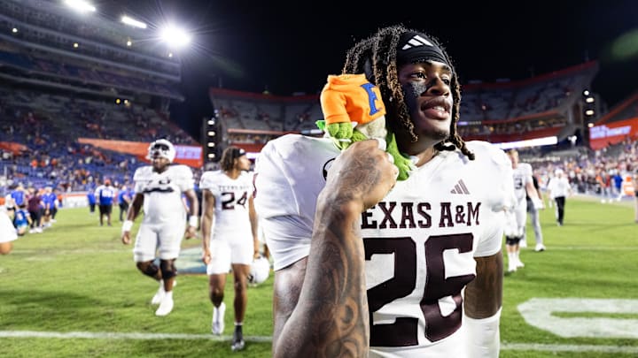Sep 14, 2024; Gainesville, Florida, USA; Texas A&M Aggies defensive back Will Lee III (26) holds a Florida Gator plush toy after defeating the Florida Gators at Ben Hill Griffin Stadium. Mandatory Credit: Matt Pendleton-Imagn Images