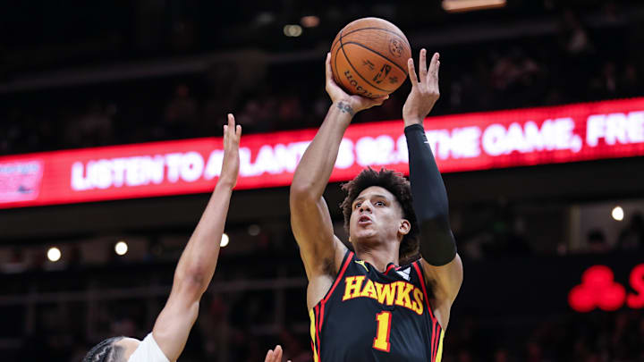 Nov 15, 2024; Atlanta, Georgia, USA; Atlanta Hawks forward Jalen Johnson (1) shoots the ball against Washington Wizards forward Kyshawn George (18) during the fourth quarter at State Farm Arena. Mandatory Credit: Jordan Godfree-Imagn Images