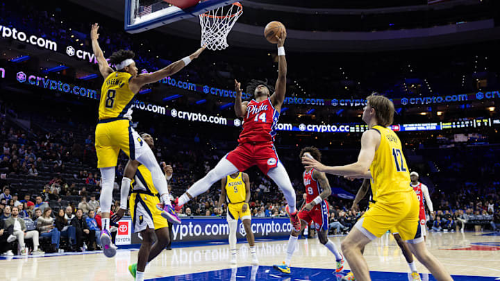 Dec 13, 2024; Philadelphia, Pennsylvania, USA; Philadelphia 76ers guard Ricky Council IV (14) drives for a shot against Indiana Pacers forward Enrique Freeman (8) during the fourth quarter at Wells Fargo Center. Mandatory Credit: Bill Streicher-Imagn Images