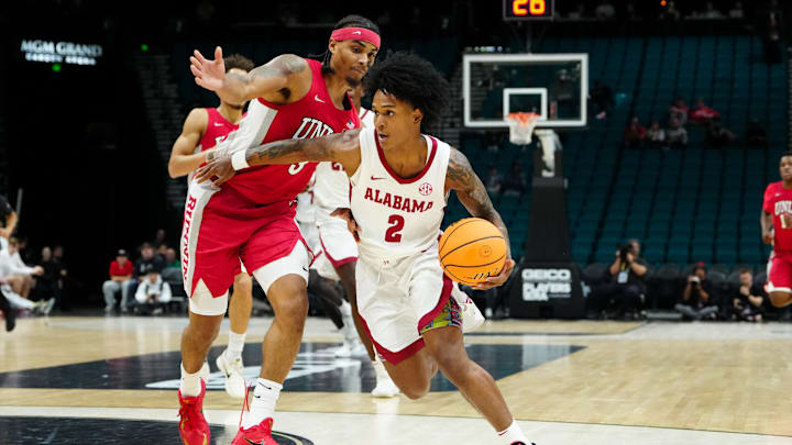 Nov 25, 2025; Las Vegas, Nevada, USA; Alabama Crimson Tide guard Aden Holloway (2) drives the ball in the first half against UNLV Rebels in a 2025 Players Era Festival group play game at MGM Grand Garden Arena. Mandatory Credit: Stephen R. Sylvanie-Imagn Images