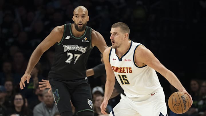 Apr 30, 2026; Minneapolis, Minnesota, USA; Denver Nuggets center Nikola Jokic (15) dribbles the ball past Minnesota Timberwolves center Rudy Gobert (27) in the first half during game six of the first round of the 2026 NBA Playoffs at Target Center.