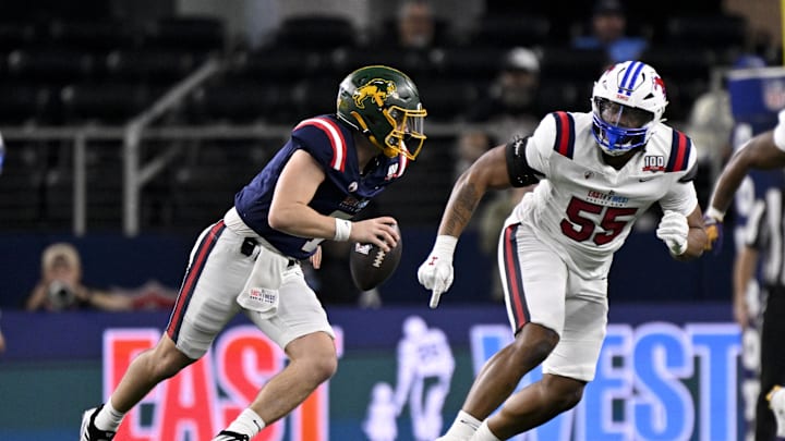 Jan 30, 2025; Arlington, TX, USA; East quarterback Cam Miller of North Dakota State (7) rolls out to avoid the rush of West edge rusher Elijah Roberts of SMU (55) during the first half at AT&T Stadium. Mandatory Credit: Jerome Miron-Imagn Images