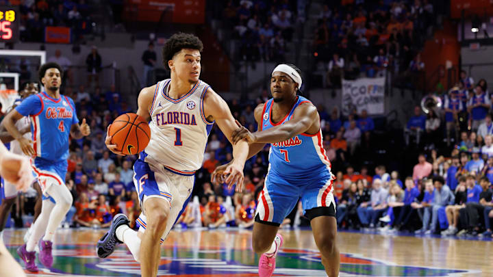 Mar 8, 2025; Gainesville, Florida, USA; Florida Gators guard Walter Clayton Jr. (1) drives to the basket past Mississippi Rebels guard Davon Barnes (7) during the second half at Exactech Arena at the Stephen C. O'Connell Center. Mandatory Credit: Matt Pendleton-Imagn Images
