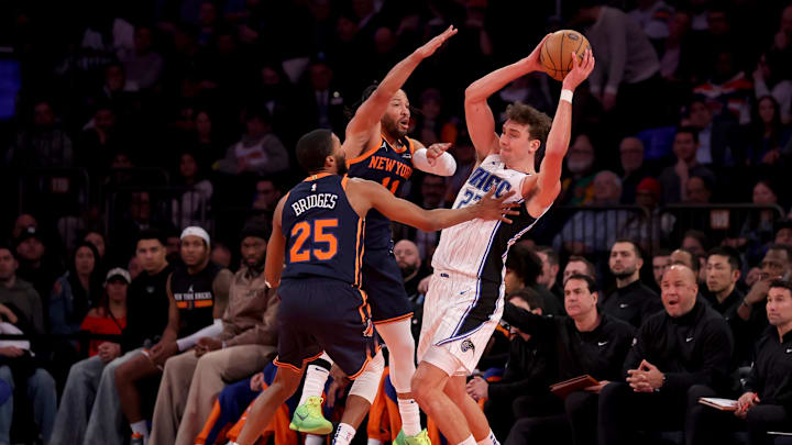 Dec 3, 2024; New York, New York, USA; Orlando Magic forward Franz Wagner (22) looks to pass the ball against New York Knicks forward Mikal Bridges (25) and guard Jalen Brunson (11) during the third quarter at Madison Square Garden. Mandatory Credit: Brad Penner-Imagn Images