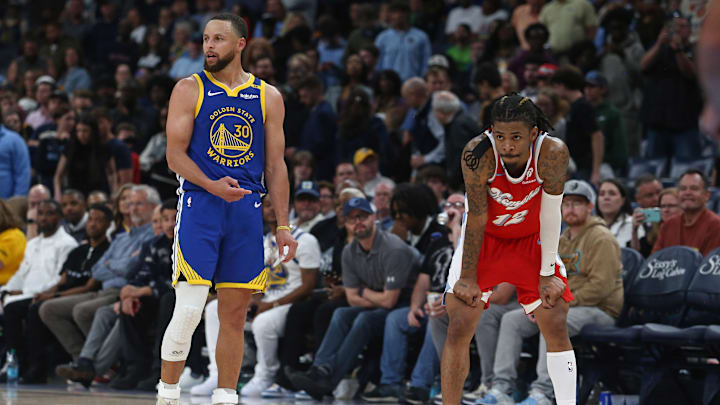 Apr 1, 2025; Memphis, Tennessee, USA; Golden State Warriors guard Stephen Curry (30) and Memphis Grizzlies guard Ja Morant (12) wait for play to resume during the fourth quarter at FedExForum. Mandatory Credit: Petre Thomas-Imagn Images