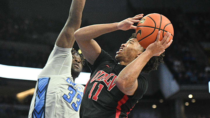 UNLV Rebels guard Dedan Thomas Jr. (11) drives against Creighton Bluejays center Fredrick King (33) in the first half at CHI Health Center Omaha. 