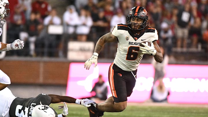Sep 23, 2023; Pullman, Washington, USA; Oregon State Beavers running back Damien Martinez (6) is tripped up by Washington State Cougars defensive back Cam Lampkin (3) in the second half at Gesa Field at Martin Stadium. Mandatory Credit: James Snook-USA TODAY Sports