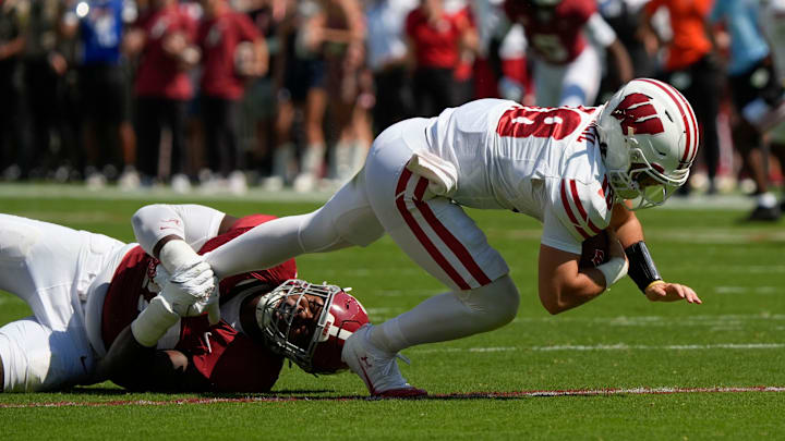 Sep 13, 2025; Tuscaloosa, Alabama, USA; Alabama defensive lineman LT Overton (22) sacks Wisconsin quarterback Danny O'Neil (18) at Saban Field at Bryant-Denny Stadium.