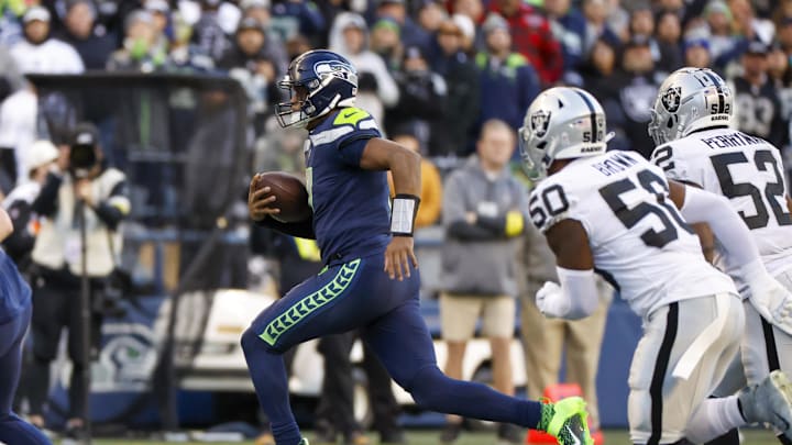 Geno Smith scrambles against the Raiders in 2022.