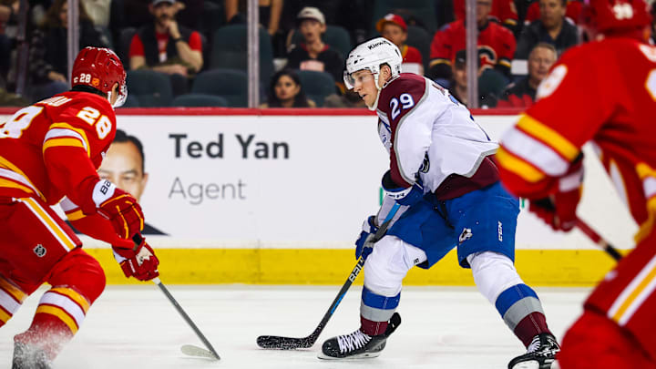 Apr 14, 2026; Calgary, Alberta, CAN; Colorado Avalanche center Nathan MacKinnon (29) controls the puck against the Calgary Flames during the first period at Scotiabank Saddledome. Mandatory Credit: Sergei Belski-Imagn Images