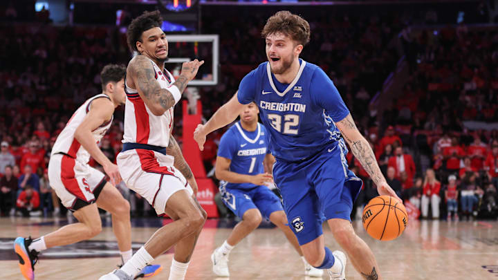 Feb 21, 2026; New York, New York, USA;  Creighton Bluejays forward Owen Freeman (32) drives past  St. John's Red Storm forward Dillon Mitchell (1) in the first half at Madison Square Garden. Mandatory Credit: Wendell Cruz-Imagn Images