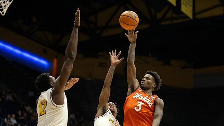 Jan 11, 2025; Berkeley, California, USA; Virginia Tech Hokies guard Jaydon Young (3) shoots the ball over California Golden Bears center Mady Sissoko (12) and guard Jeremiah Wilkinson (0) during the first half at Haas Pavilion. Mandatory Credit: D. Ross Cameron-Imagn Images