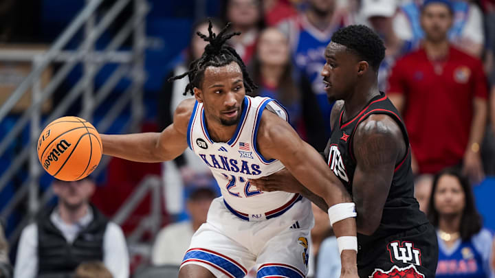 Feb 7, 2026; Lawrence, Kansas, USA; Kansas Jayhawks guard Darryn Peterson (22) drives against Utah Utes forward Seydou Traore (0) during the first half at Allen Fieldhouse. Mandatory Credit: Jay Biggerstaff-Imagn Images