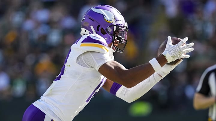 Sep 29, 2024; Green Bay, Wisconsin, USA;  Minnesota Vikings wide receiver Justin Jefferson (18) catches a pass near the sidelines during the fourth quarter against the Green Bay Packers at Lambeau Field. Mandatory Credit: Jeff Hanisch-Imagn Images